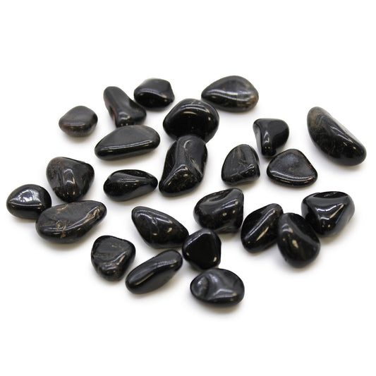 Smooth, polished black onyx tumble stones with a deep glossy finish.