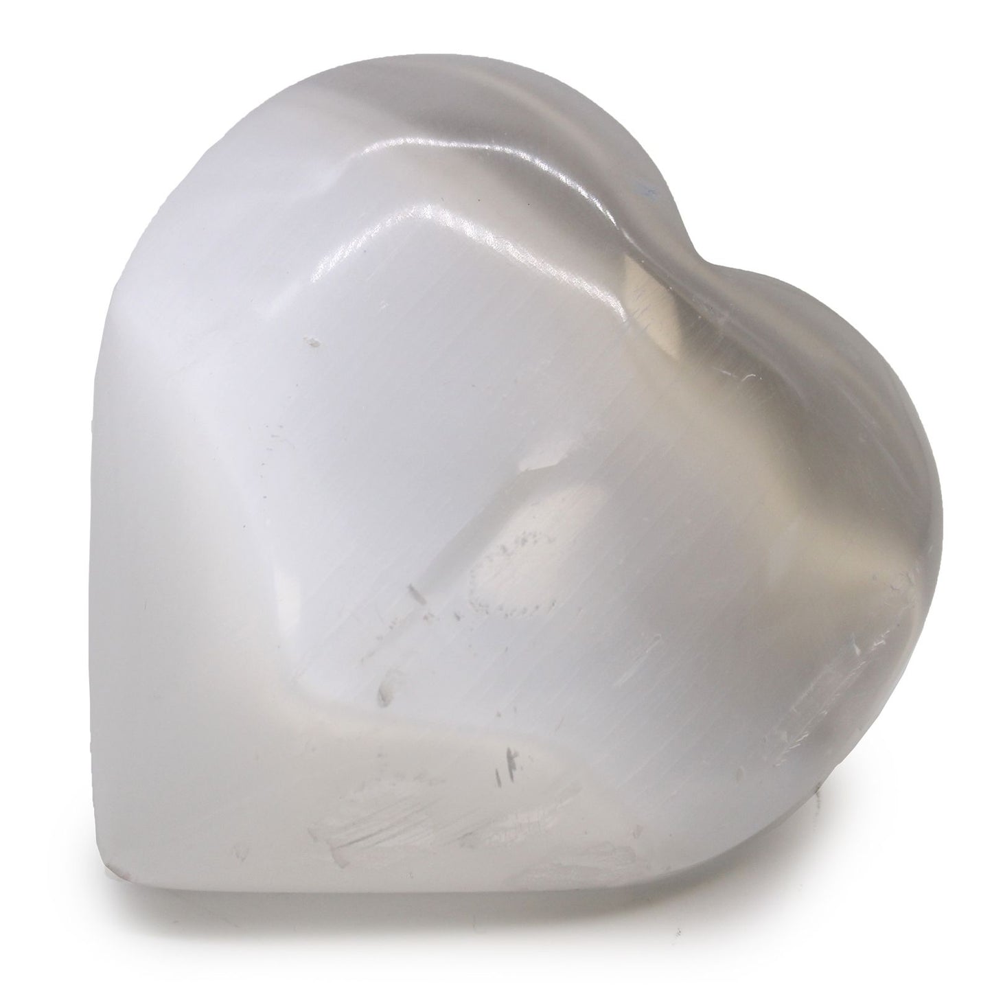 Large polished white selenite crystal carved into a smooth heart shape with a natural luminous glow.