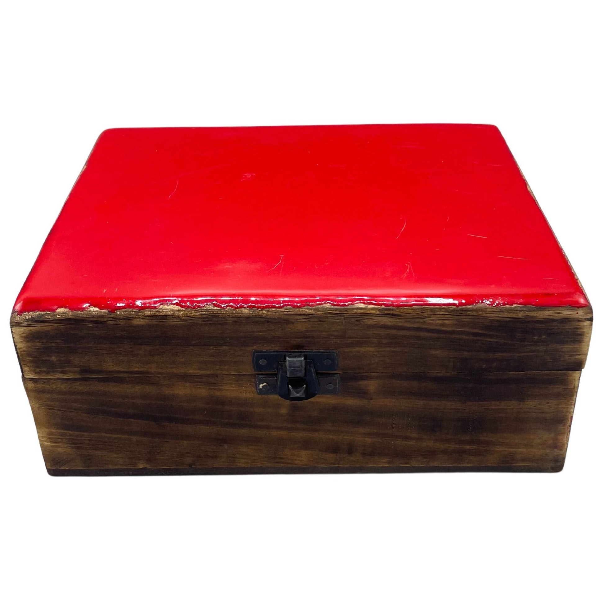 A large rectangular wooden box featuring a vibrant red ceramic glazed lid with intricate patterns.