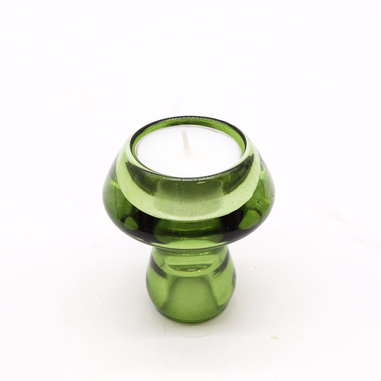 Translucent garden jade green glass mushroom-shaped holder designed for both dinner candles and tealights.