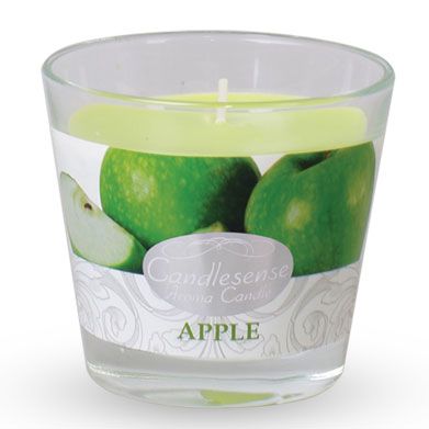 A glass jar candle with a green apple scented wax and a single wick.