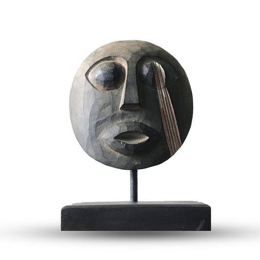 Handcrafted wooden Timor tribal mask with detailed carvings and an antique weathered finish on a dark background.