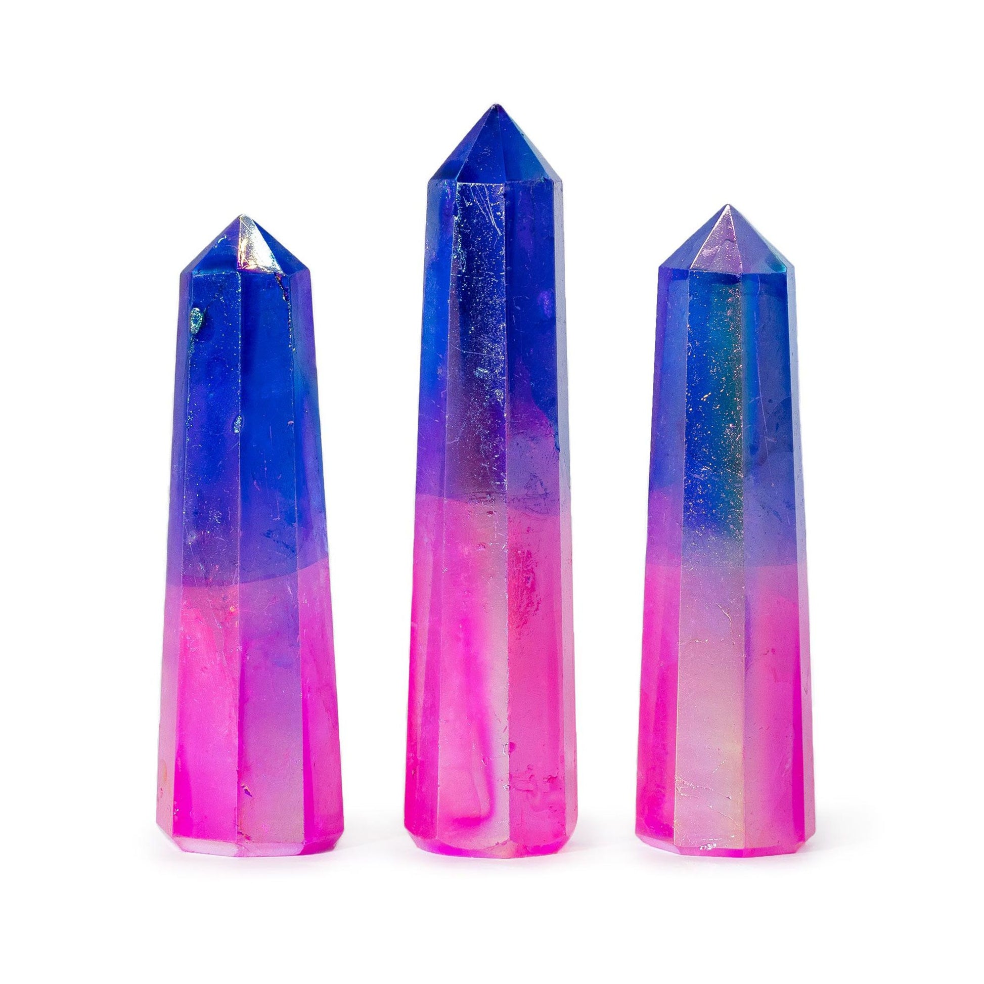 A polished gemstone obelisk with a shimmering pink and blue aurora finish and a sharp pointed tip.