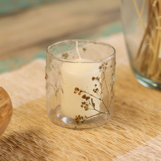 Straight glass candle holder featuring real yellow margarita flowers embedded in clear recycled glass.