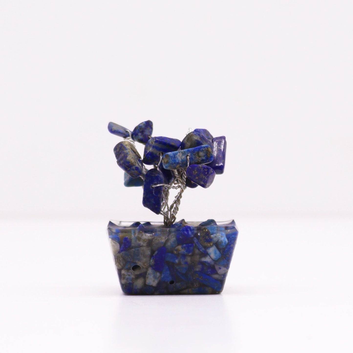 Small gemstone tree with blue sodalite stones on a decorative orgonite base with copper wire branches.