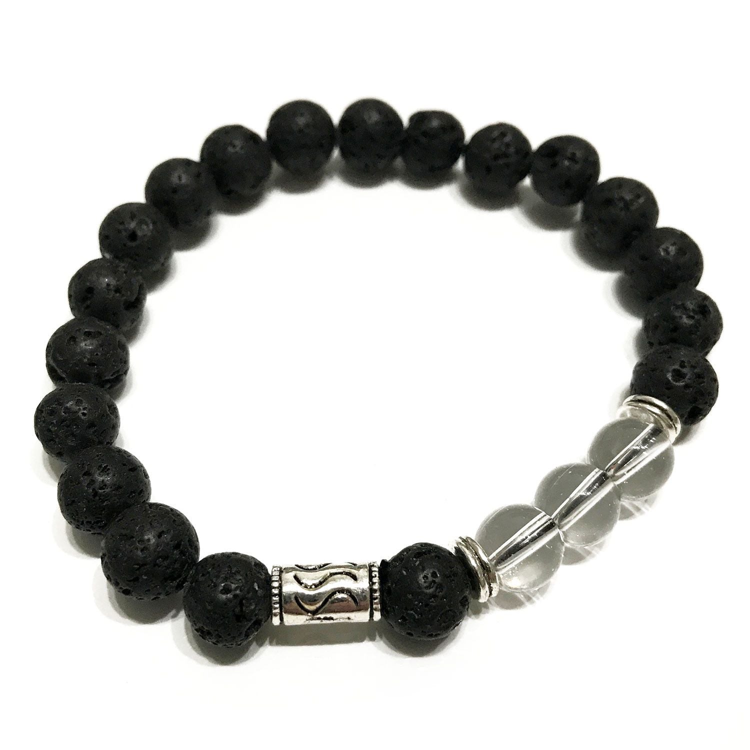 Handmade stretch bracelet featuring dark porous lava stone beads and translucent tribal rock quartz gemstones.