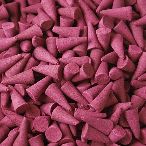 Pile of aromatic Ylang Ylang incense cones in a vibrant colour.