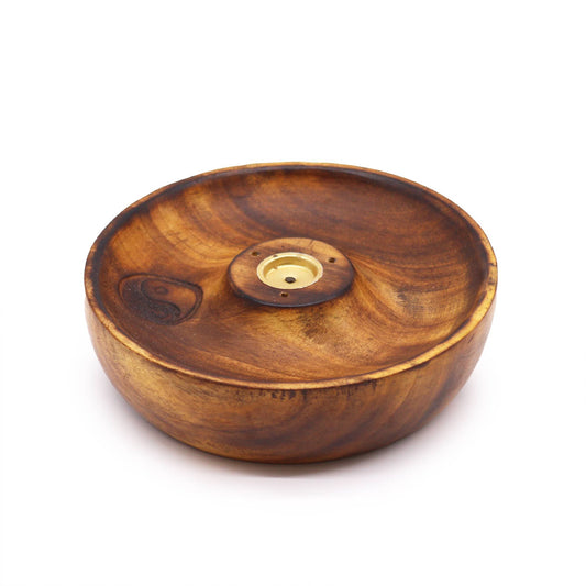Circular wooden incense burner disc with a black and white Yin and Yang symbol and holes for incense sticks.