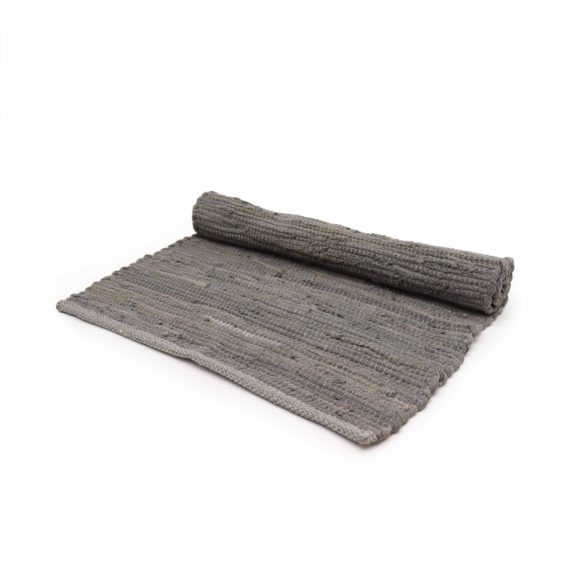 Small rectangular handwoven charcoal grey cotton rug with a textured weave and fringe detailing.