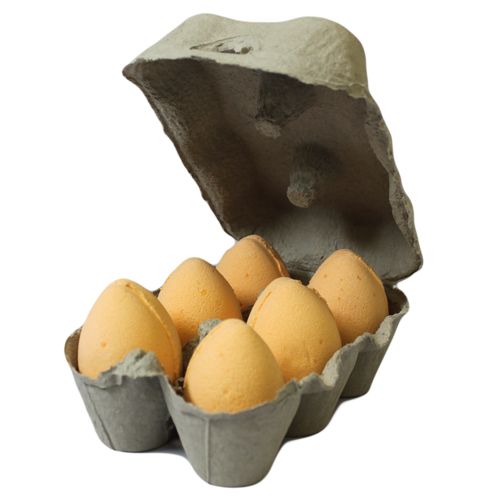 Six egg-shaped bath fizzers with a light orange tint, arranged in a simple row on a plain background.