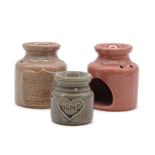 Elegant white ceramic oil burner featuring a colourful Love Home Sweet Home house design with a glazed finish.