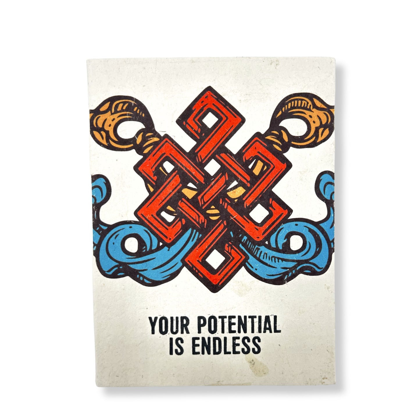 Handmade Lokta paper notebook with a vibrant red and orange cover featuring the text Your Potential is Endless.