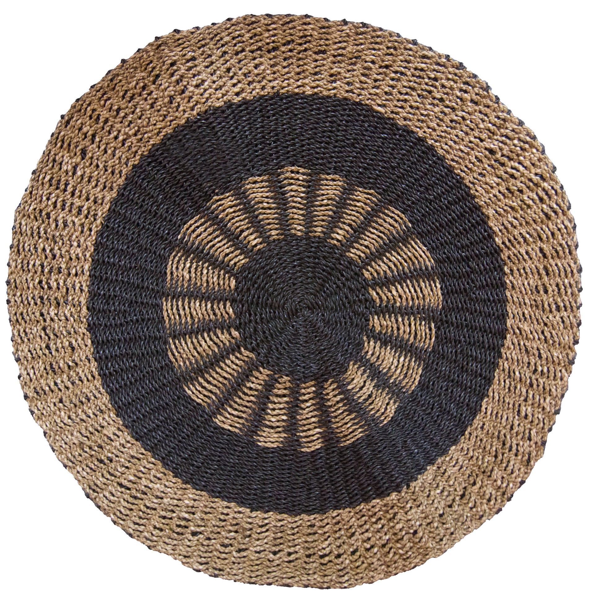 Round seagrass rug with a black and tan inner sun pattern design on a natural woven background.