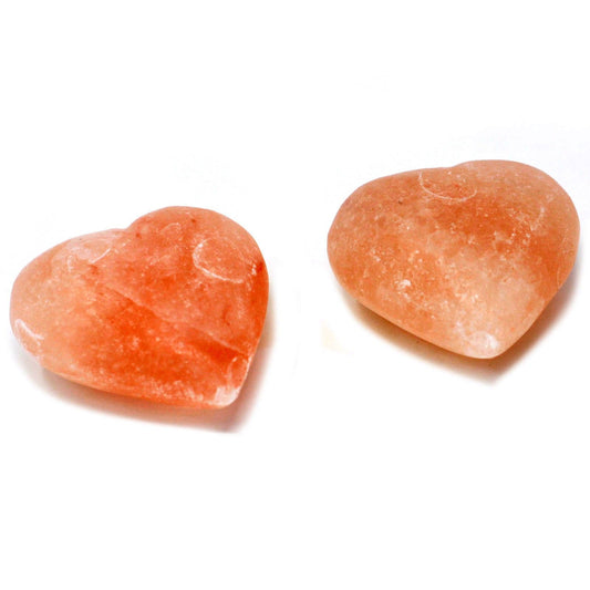 Heart-shaped pink Himalayan salt deodorant stone with a smooth, natural mineral texture.