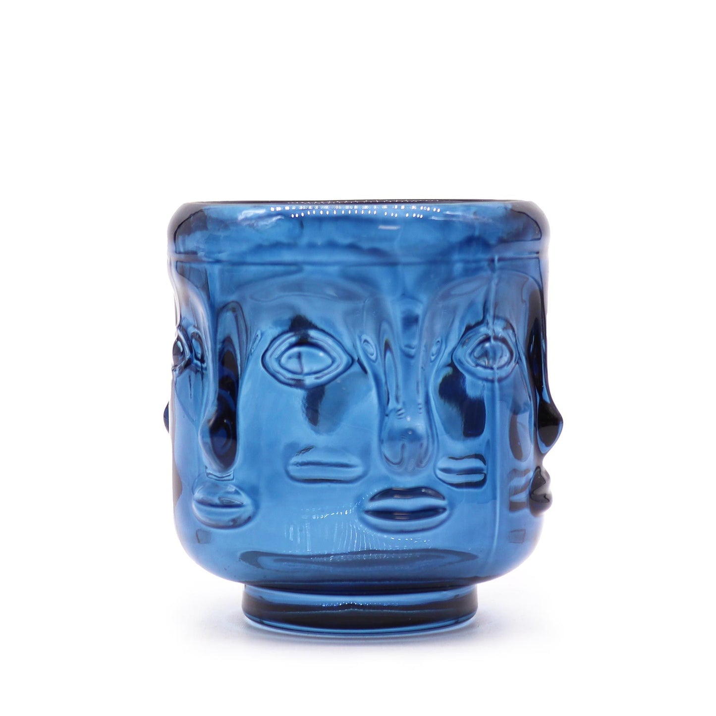 Royal blue glass candle jar featuring embossed Buddha faces in a circular pattern around the exterior.