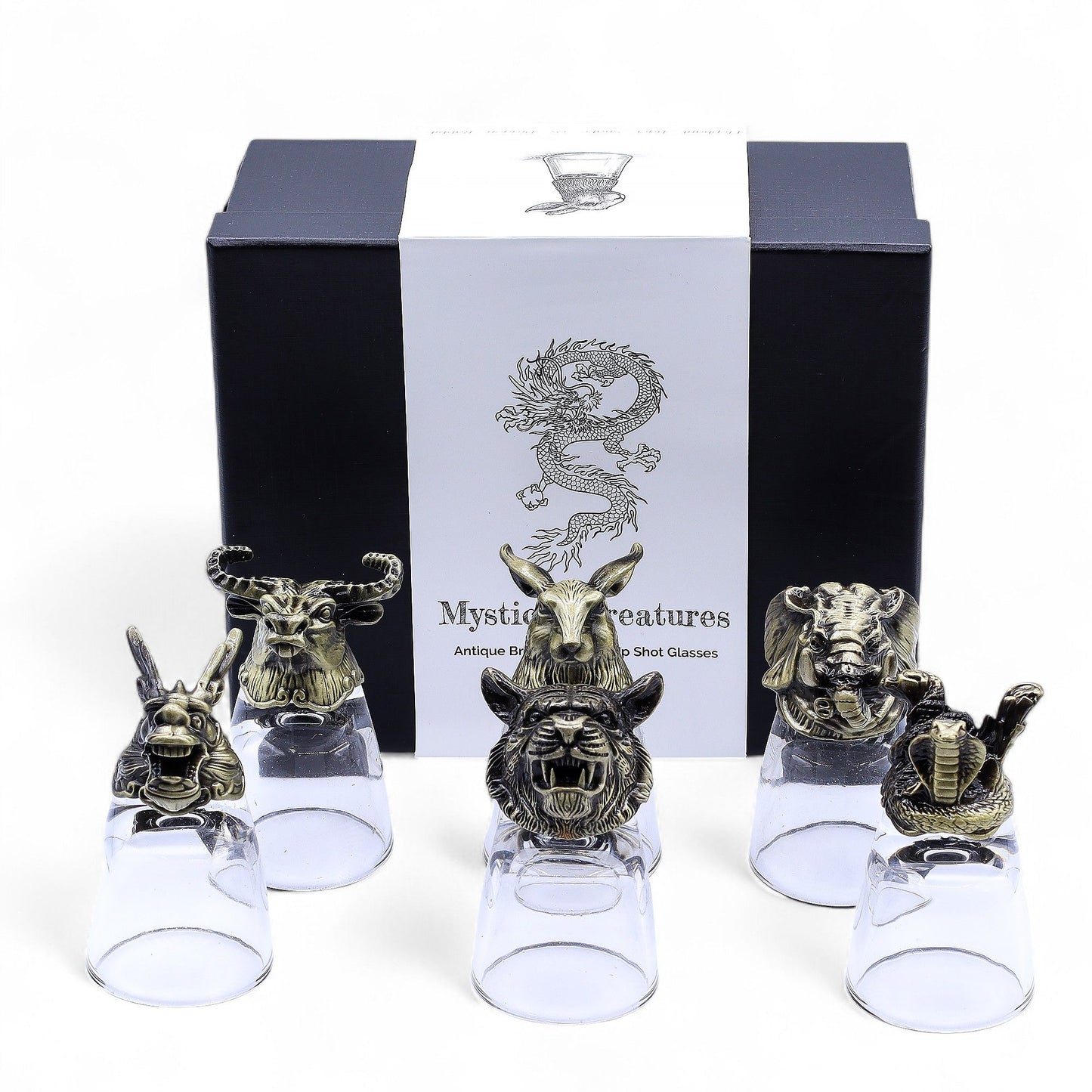 Six clear shot glasses set on ornate antique bronze bases featuring detailed mystical creatures.