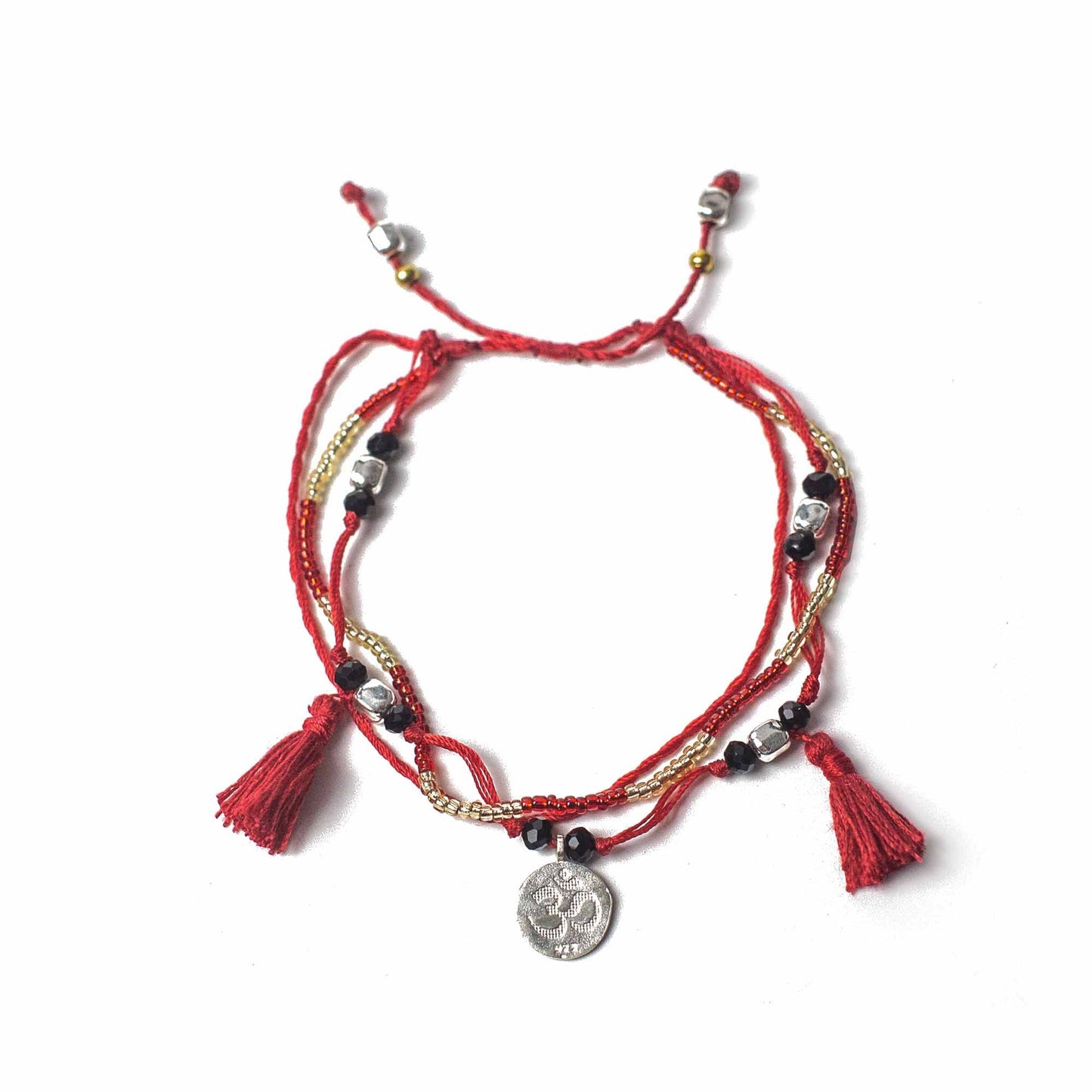 Intricate temple string bracelet with decorative silver beads and a symbolic silver charm on a woven cord.