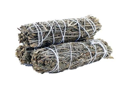A small hand-tied smudge stick made of dried green sage leaves and purple lavender sprigs.