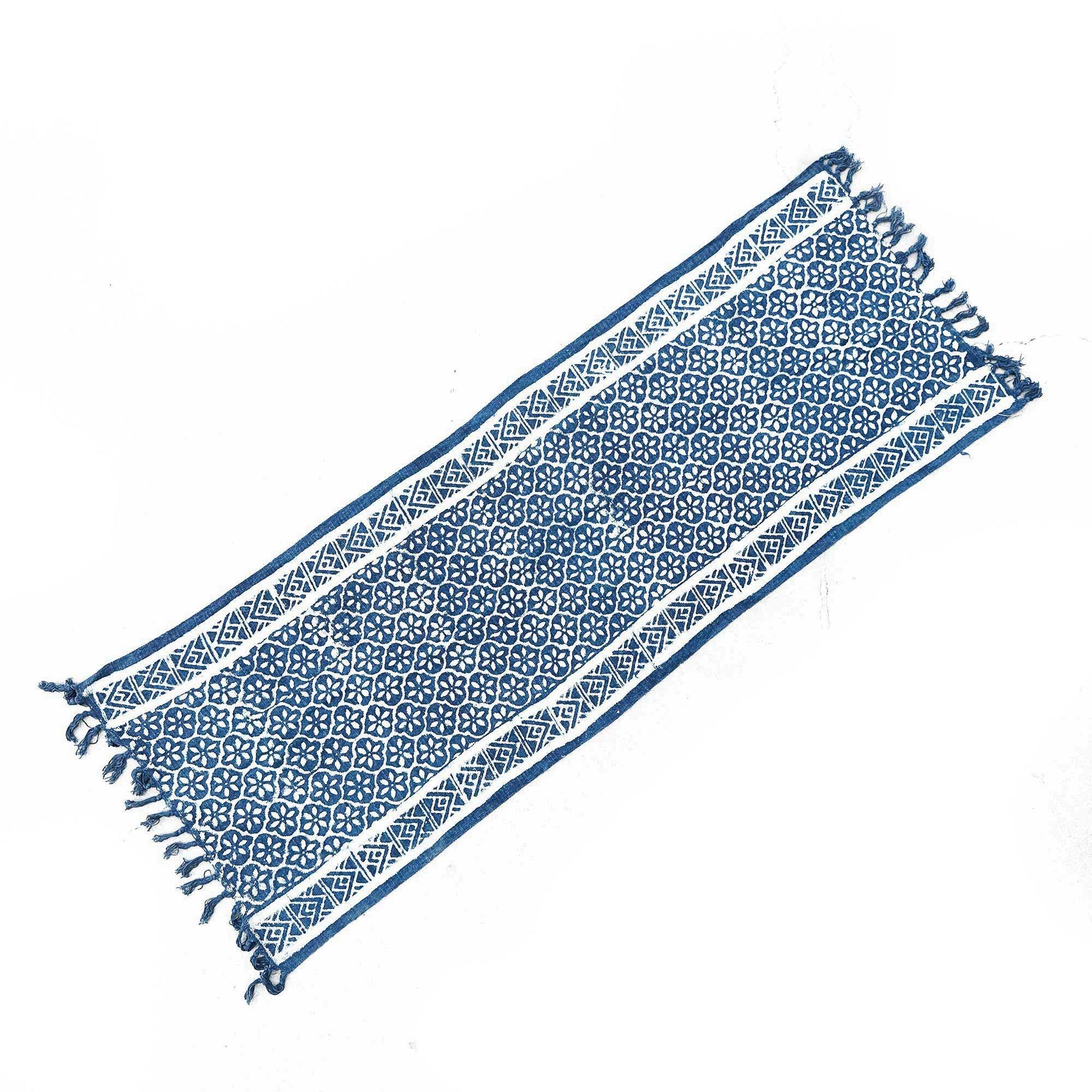 Intricately patterned indigo blue handmade runner rug with white tile-inspired geometric designs.