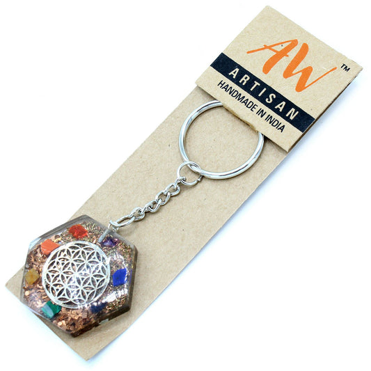 Octagonal orgonite keyring featuring a metallic Flower of Life symbol embedded in clear resin with crystals.