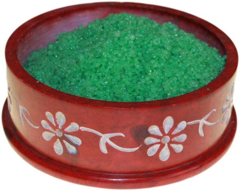 Small green scented simmering granules in a pile, reflecting a fresh forest pine aesthetic.