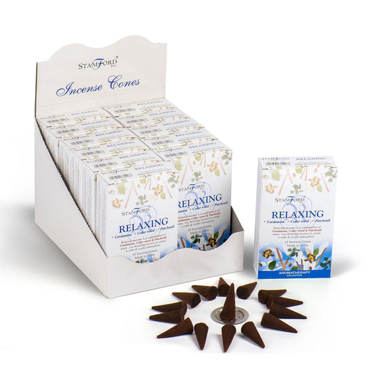 A pile of dark brown incense cones on a wooden surface with a soft focused background.