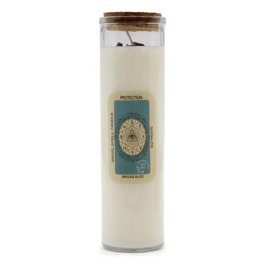 Blue soy wax spell candle topped with sodalite gemstones and dried botanicals in a glass jar.