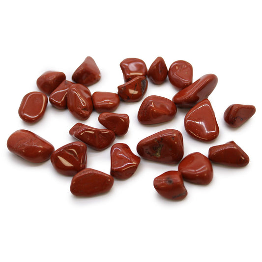 Smooth, polished red jasper tumble stones with warm terracotta hues and unique natural streaks.