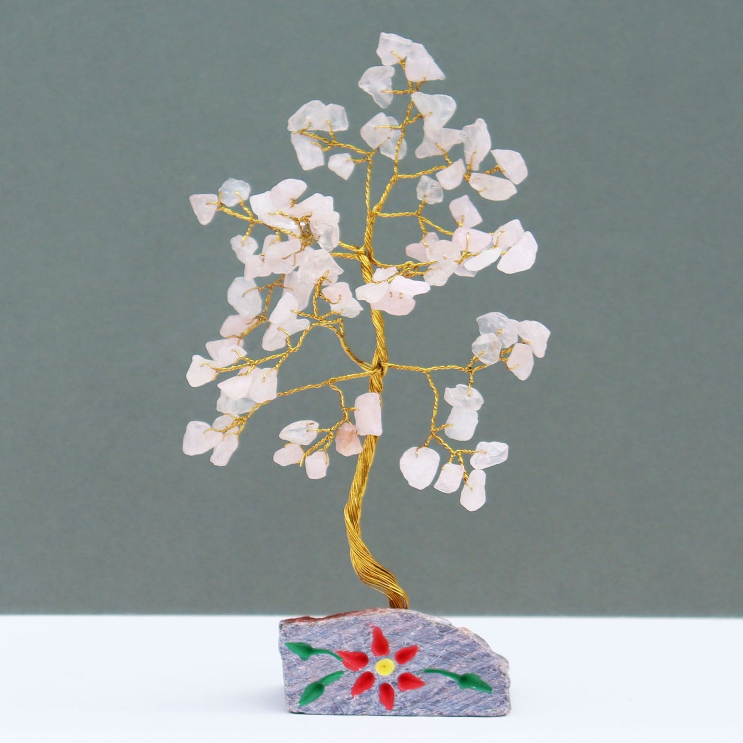 Handmade Rose Quartz crystal tree with 80 pink gemstone leaves and wire branches on a natural stone base.