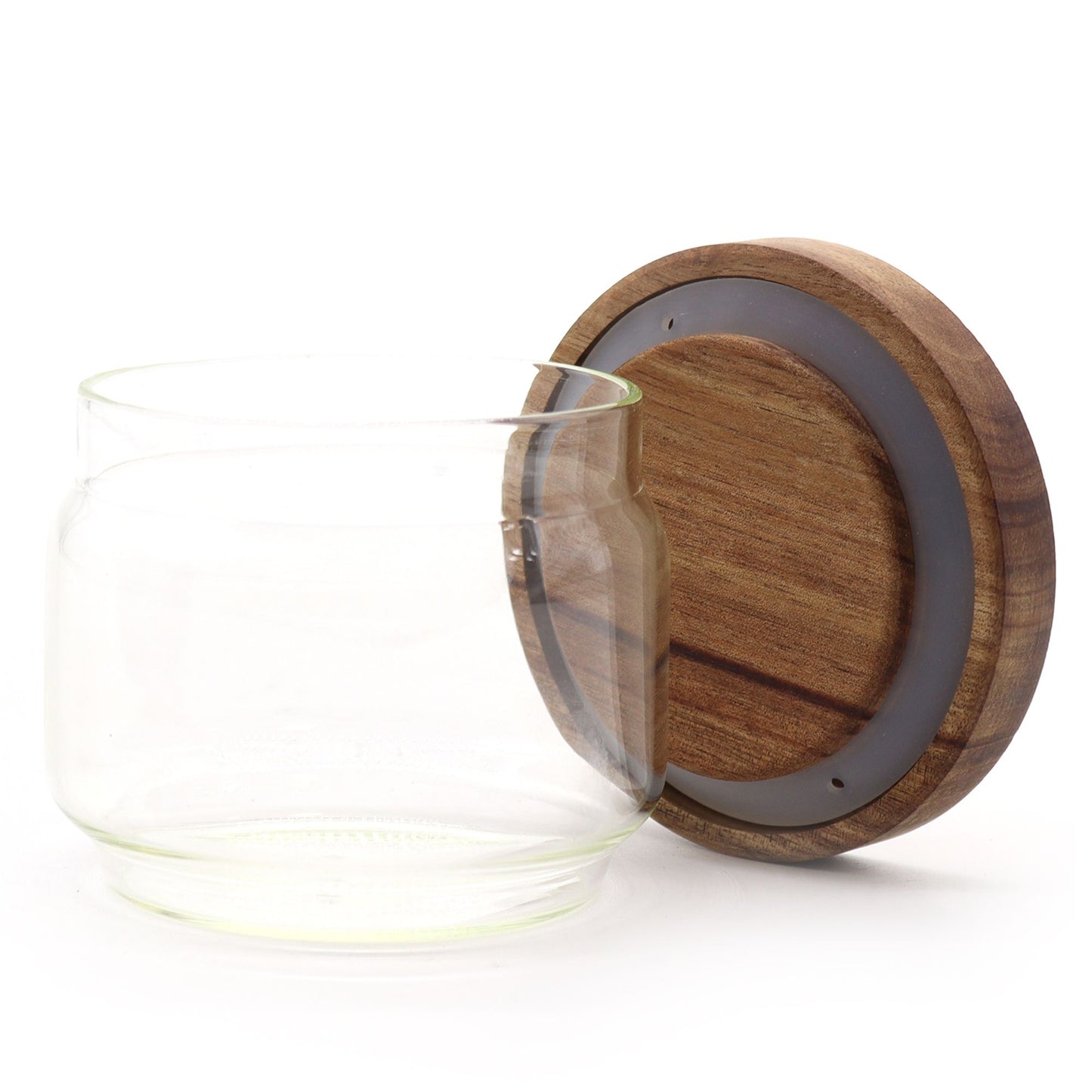 Small clear glass jar with a natural sustainable bamboo lid in a minimalist cottage style.