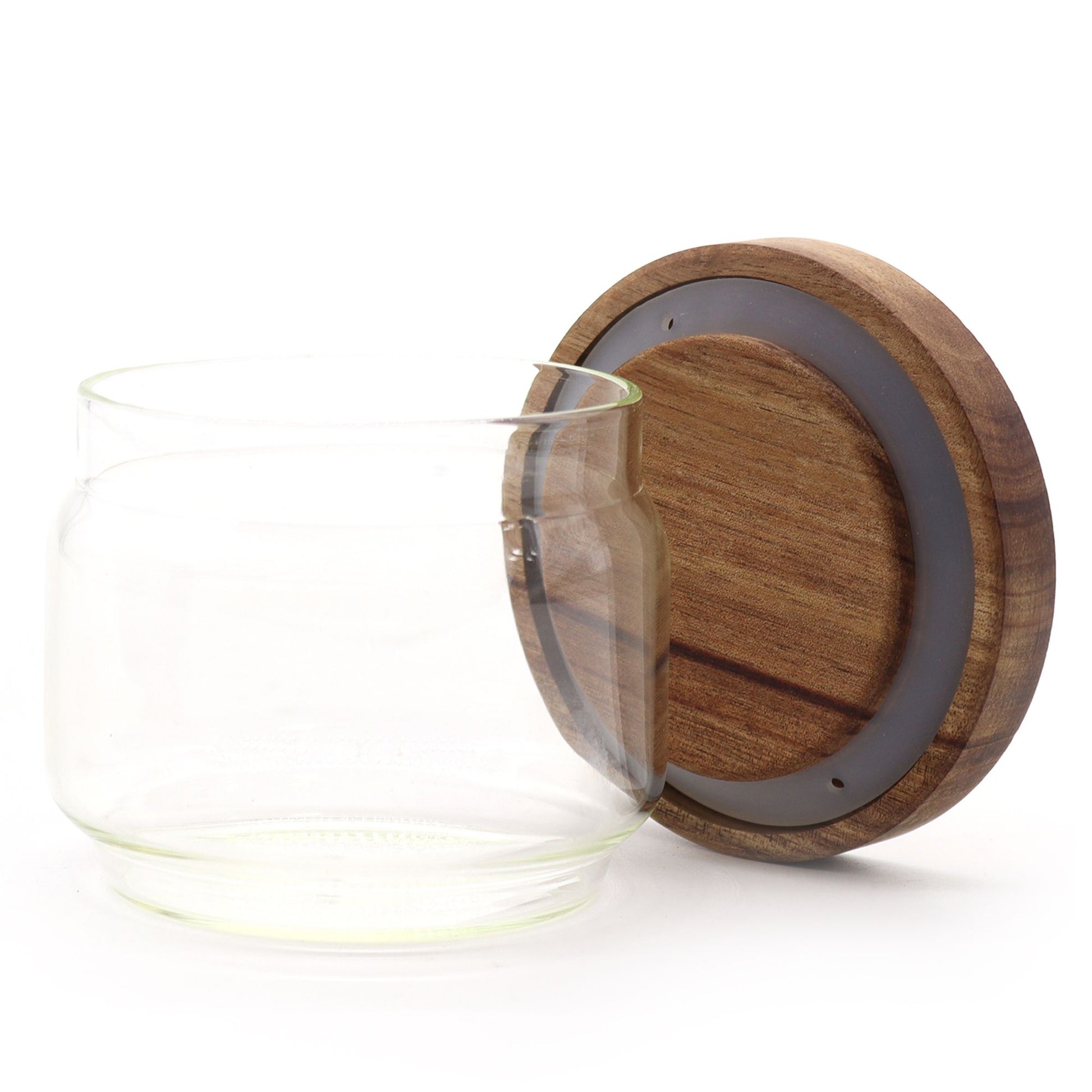 Small clear glass jar with a natural sustainable bamboo lid in a minimalist cottage style.