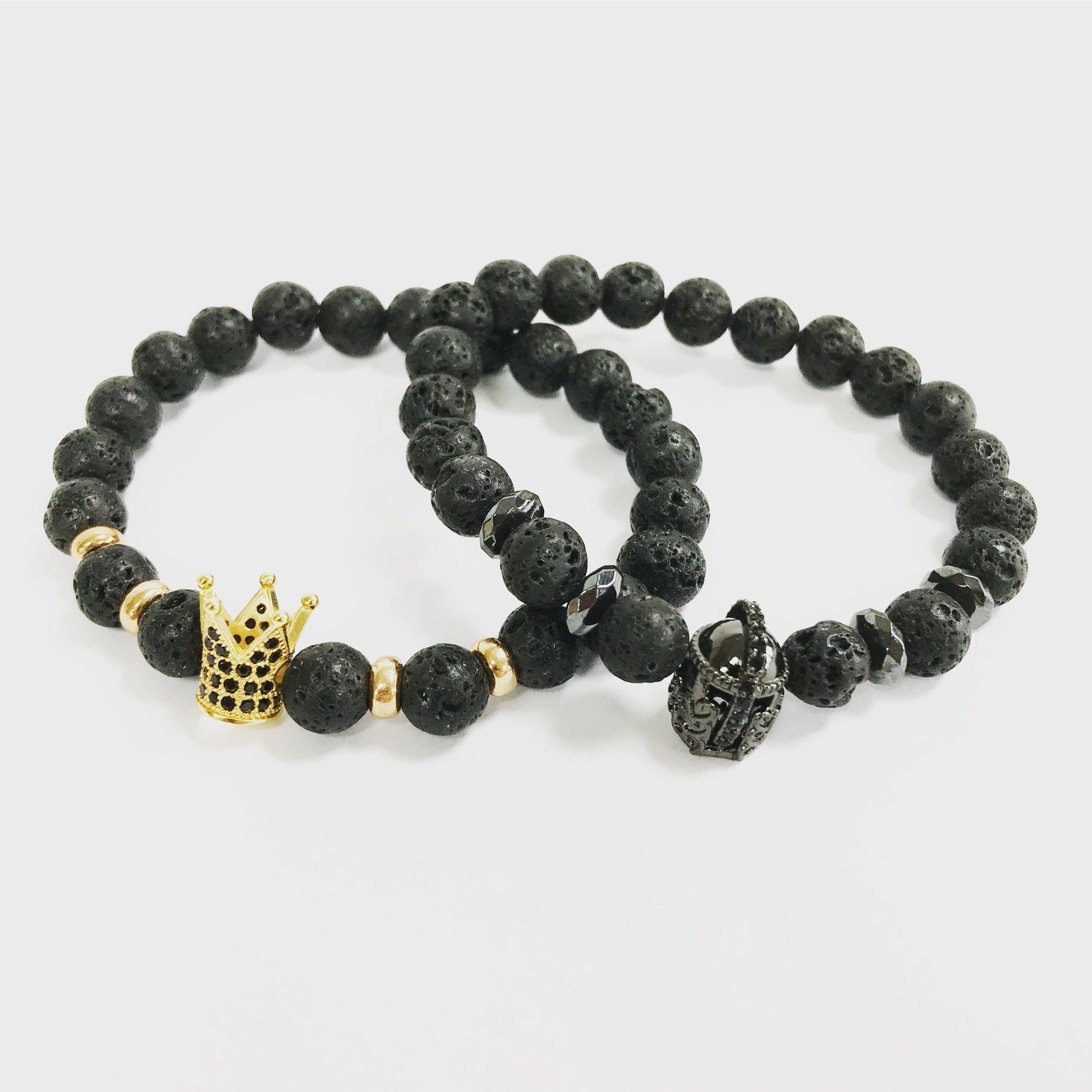 Beaded gemstone bracelet featuring black lava stone beads and a silver-tone knight's helmet charm.
