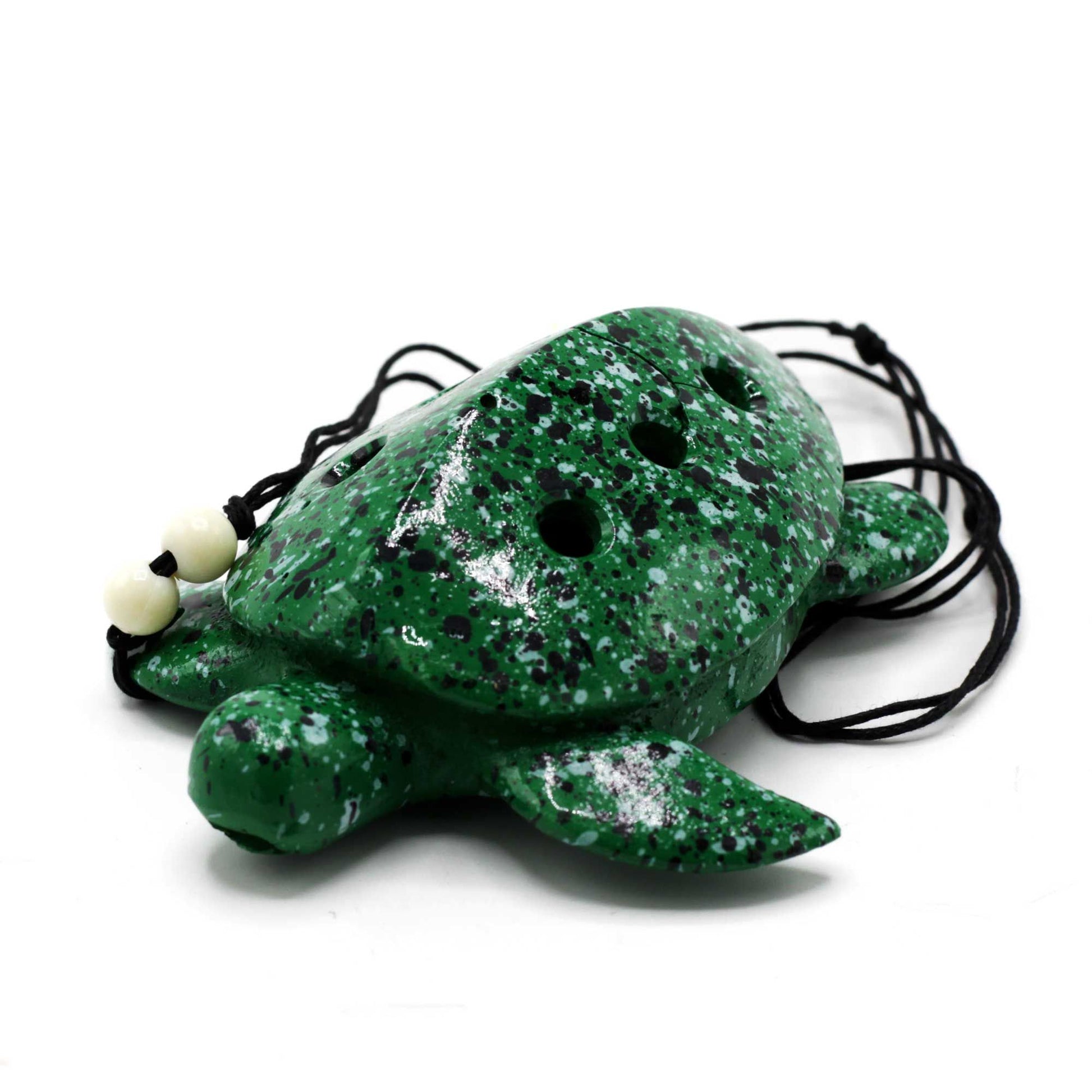 Handcrafted ceramic ocarina shaped like a turtle with decorative patterns and precisely tuned finger holes.