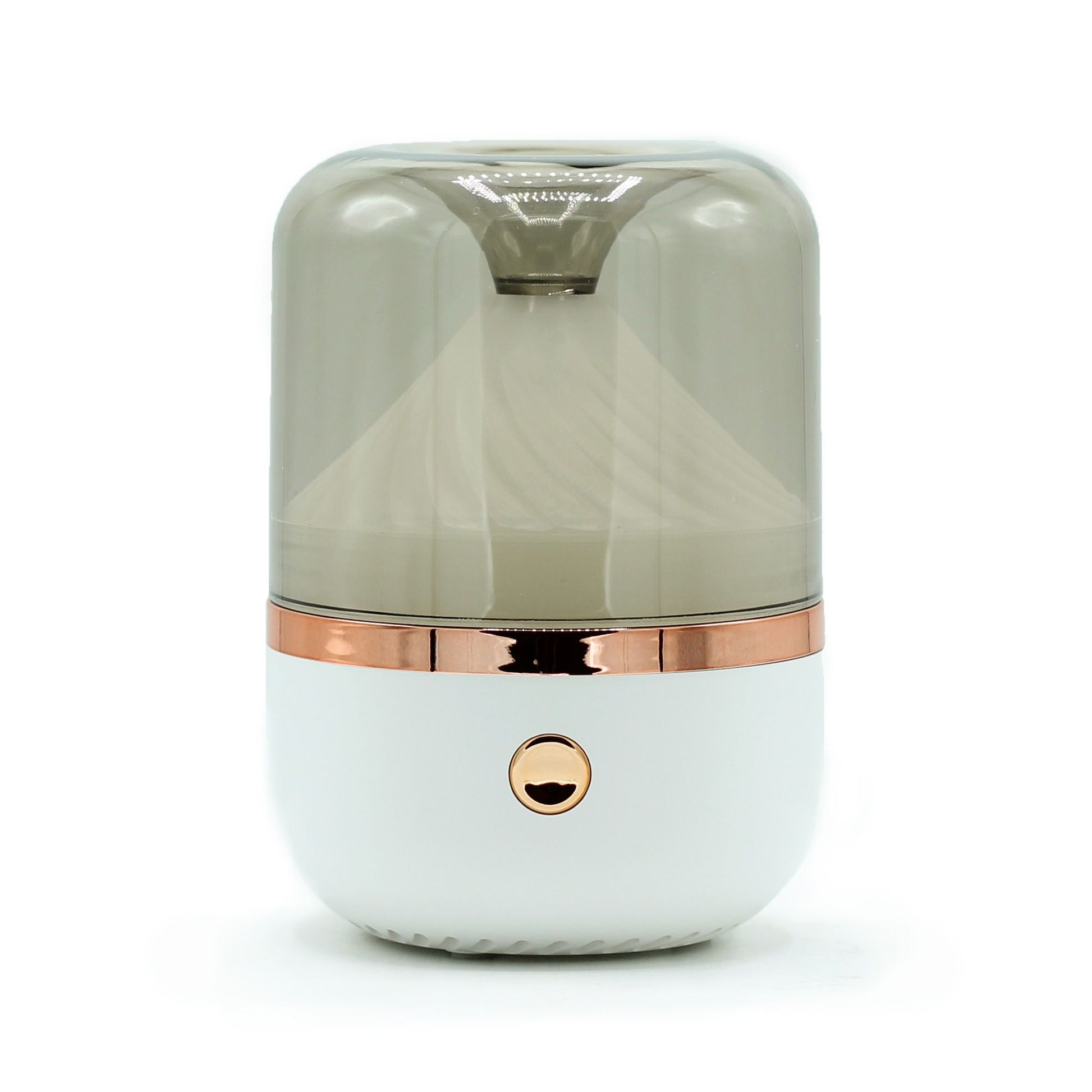 Minimalist white and bronze cylindrical aroma diffuser with soft ambient lighting.