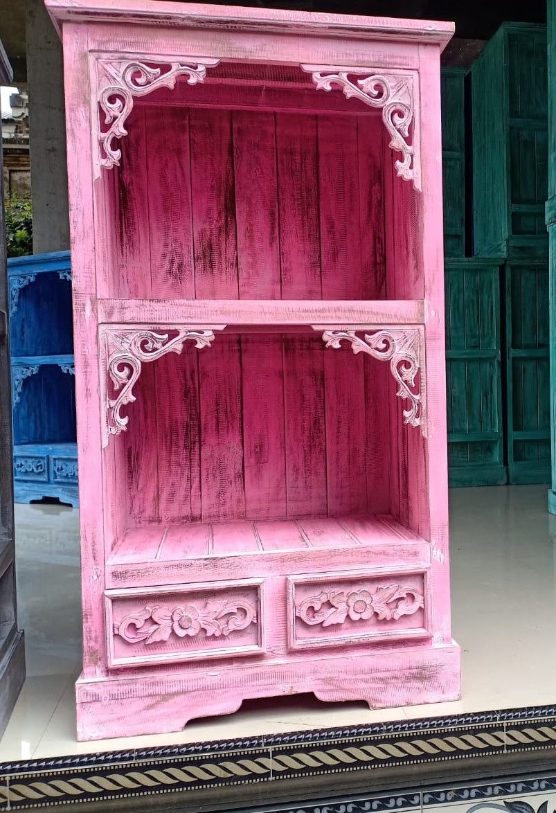 Handcrafted pinkwash wooden bathroom cabinet with a tall slender design, featuring drawers and shelving.