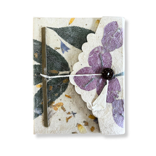 Large handmade Lokta paper notebook featuring vibrant purple pressed bougainvillea petals on a natural textured cover.