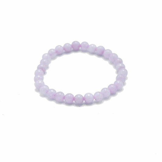Delicate elasticated bracelet featuring polished pale pink rose quartz gemstone beads.