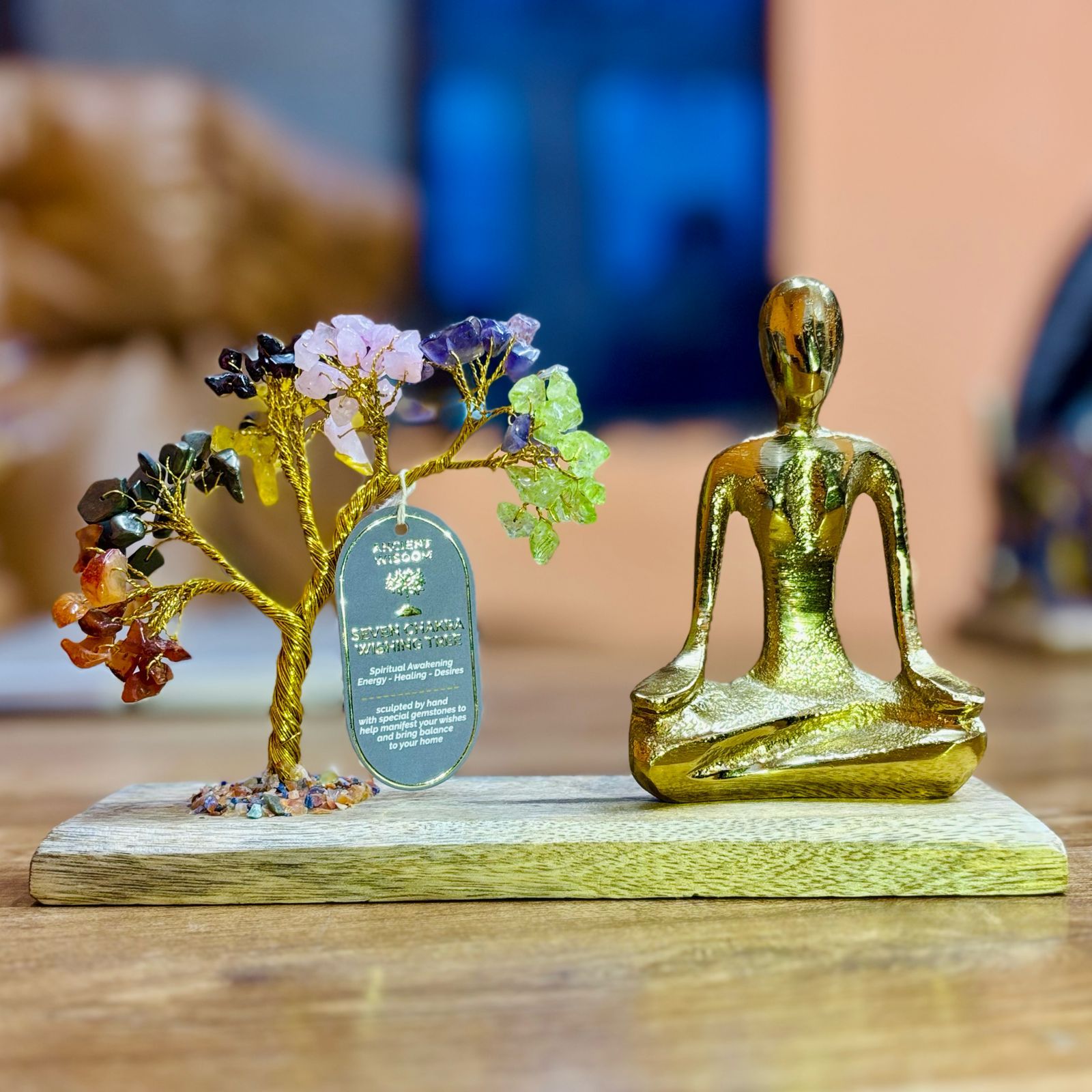 Handcrafted yoga garden figurine in mudra pose with a tilted seven chakra gemstone tree featuring 100 colourful chipstones.