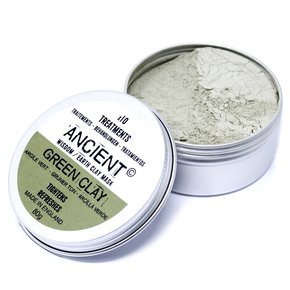 Finely milled green illite clay powder in a clear glass jar for a detoxifying facial mask treatment.