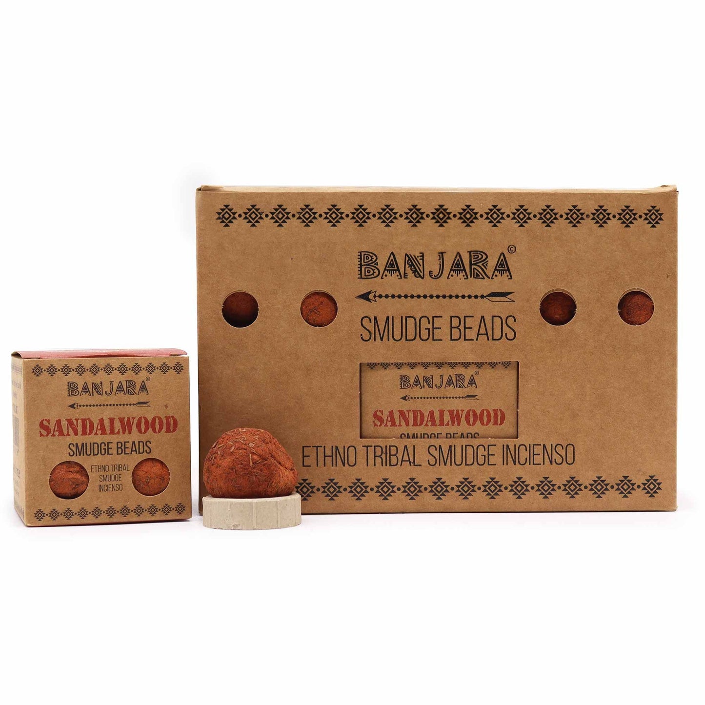 Five dark brown aromatic smudge beads arranged next to a small ceramic burner on a neutral background.