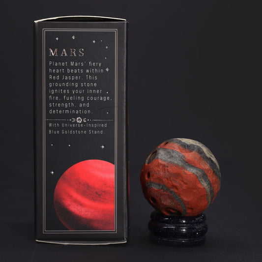 Polished red jasper sphere representing Mars resting on a sparkling goldstone base.