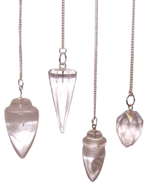 Clear rock quartz gemstone pendulum hanging from a delicate silver-tone chain.
