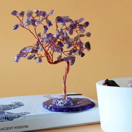 Large gemstone tree with purple amethyst leaves and twisted wire branches set on a polished natural agate slab base.