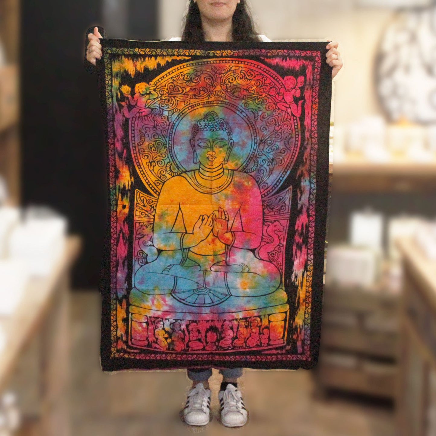 Intricate cotton wall hanging depicting a peaceful Buddha with vibrant colours and a deep black background.