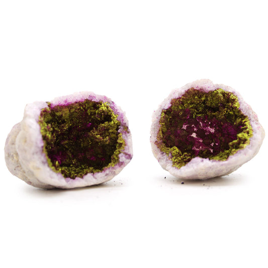 A natural pink and gold coloured calcite geode rock showing shimmering internal crystals.