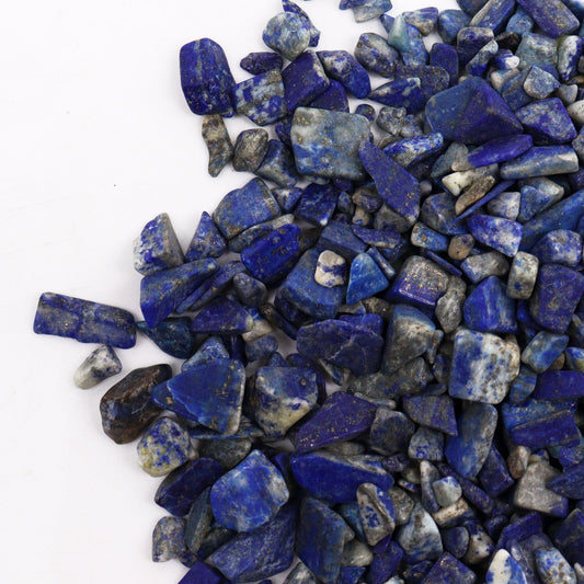 Large bag of deep blue Lapis Lazuli gemstone chips with natural golden pyrite flecks.