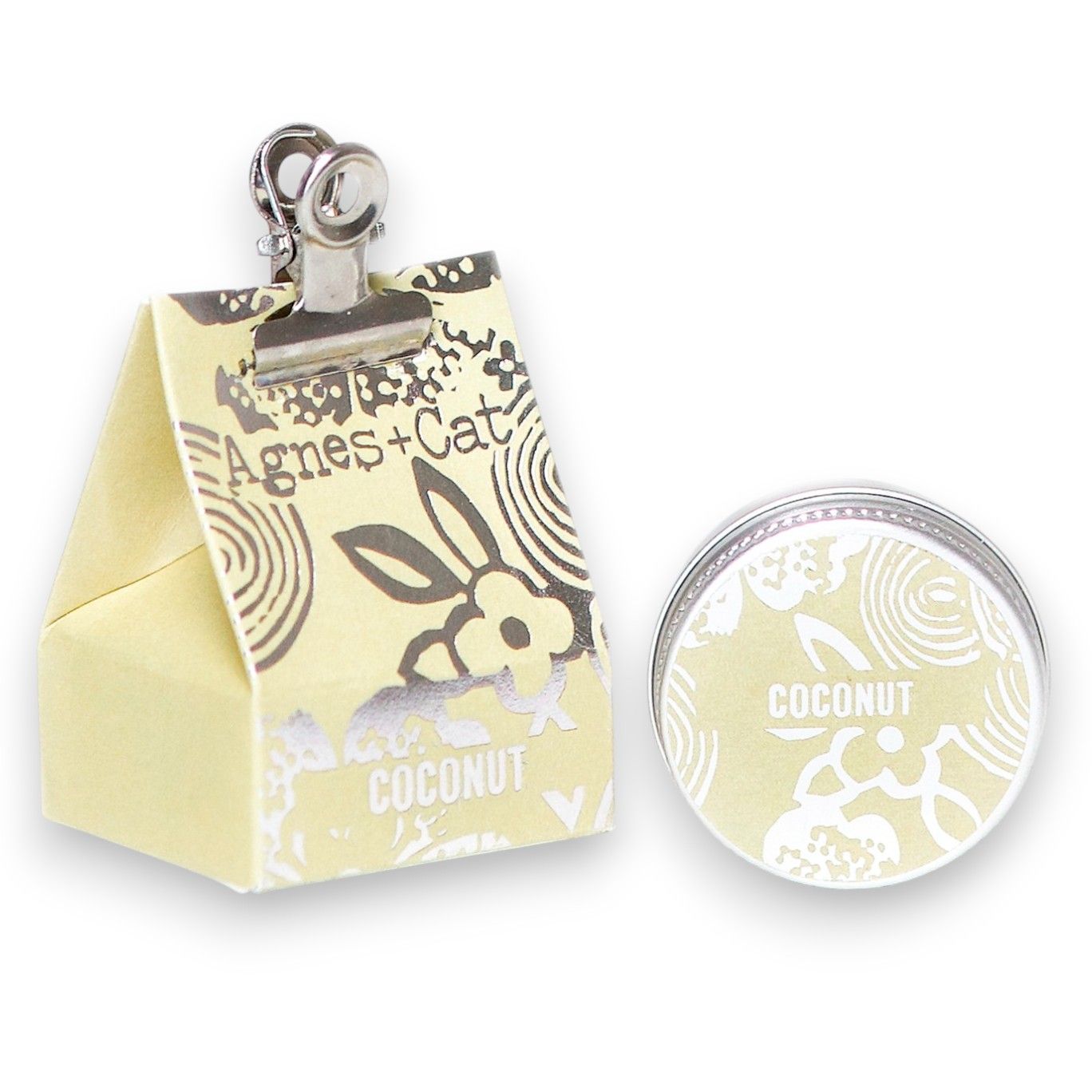 Small round tin of creamy coconut lip balm with a smooth texture and natural finish.