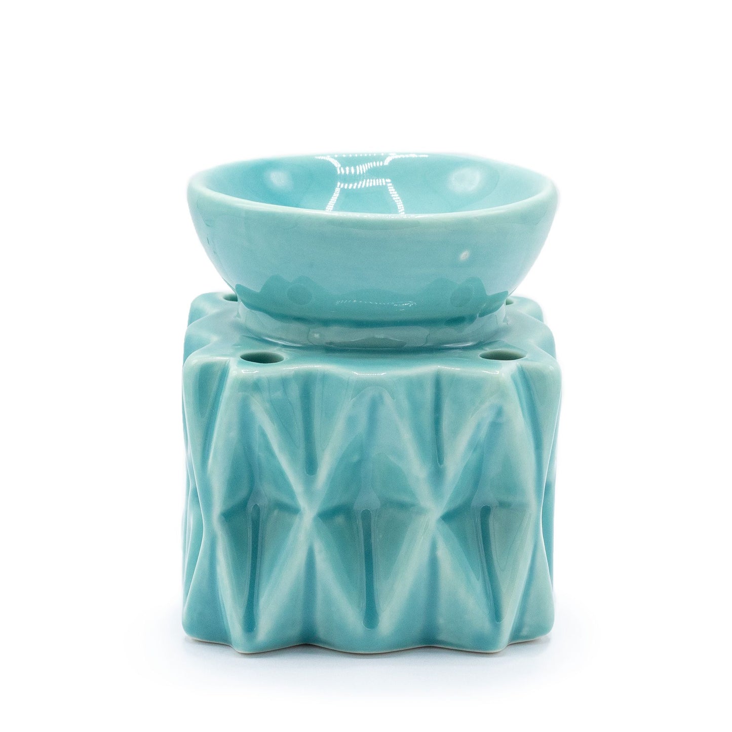 Contemporary blue ceramic oil burner with a geometric cutout pattern and a gloss finish.