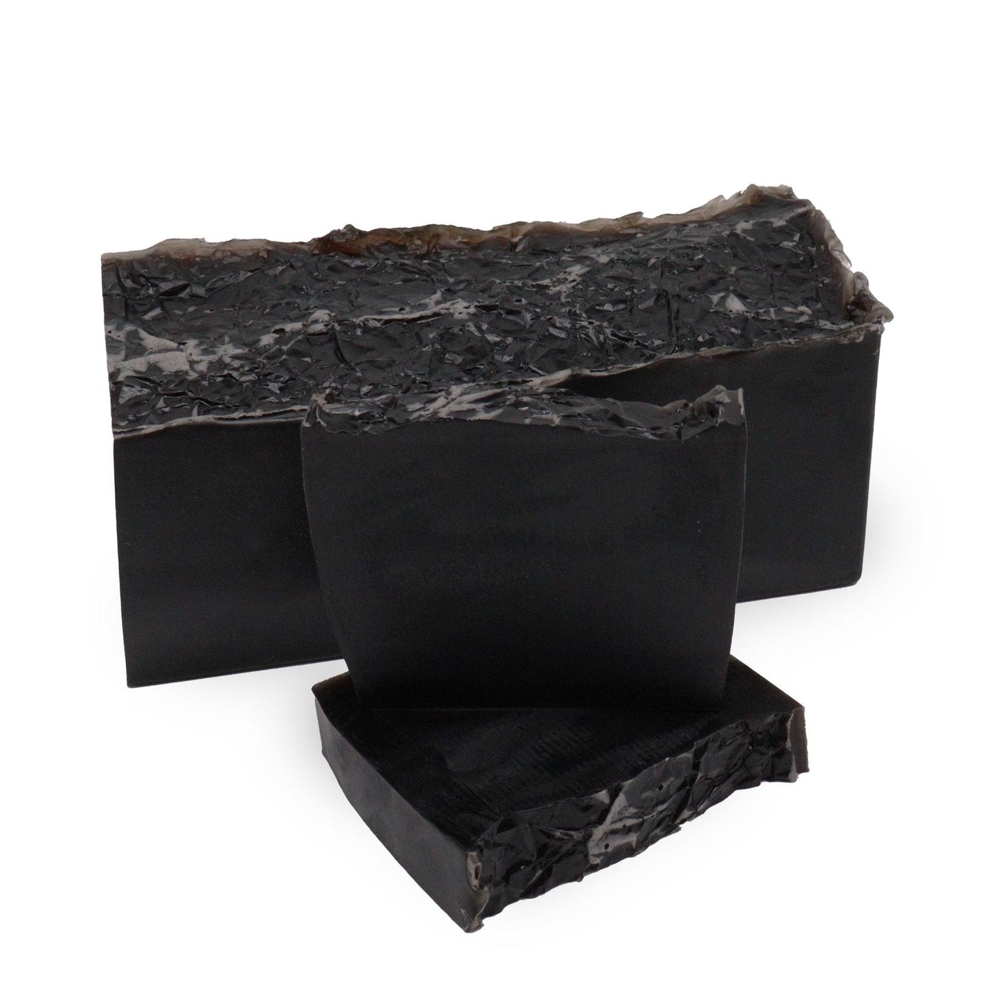 Hand-crafted soap loaf with a marbled dark and light texture, reflecting the Harmony Noir scent of white fig and vanilla.
