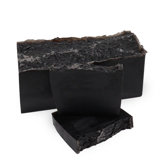 Hand-crafted soap loaf with a marbled dark and light texture, reflecting the Harmony Noir scent of white fig and vanilla.
